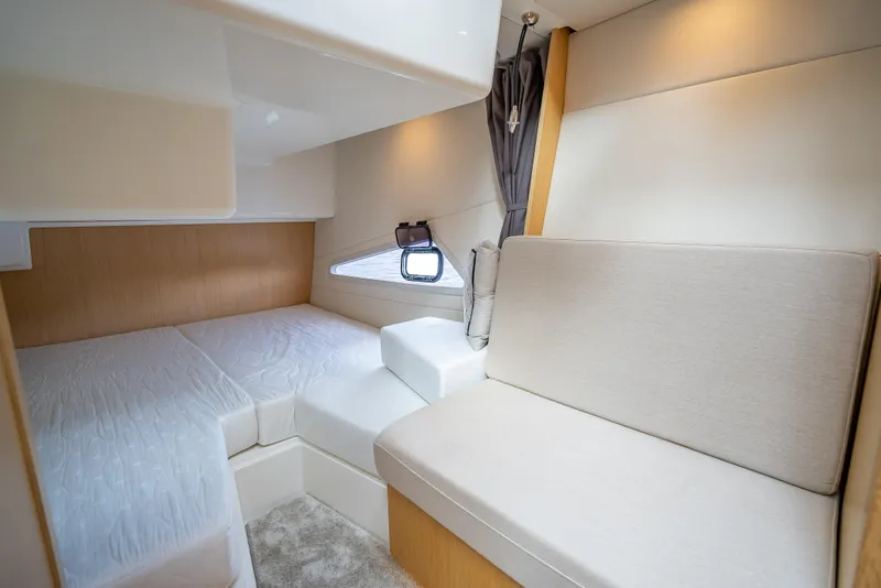 Slide: The Image of 2021 Skamander Monaco cabin interior with bed and seating, featuring modern design and soft lighting. - 15