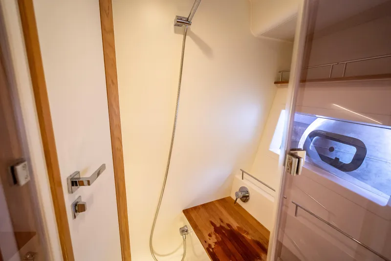 Slide: The Image of Modern shower area in 2021 Skamander Monaco yacht with wooden bench and window. - 17