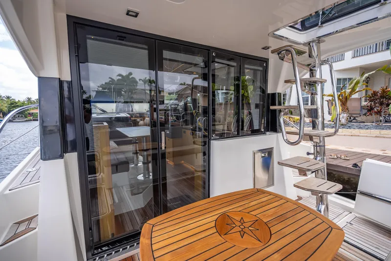 Slide: The Image of 2021 Skamander Monaco yacht interior with wooden table and spiral staircase. - 20