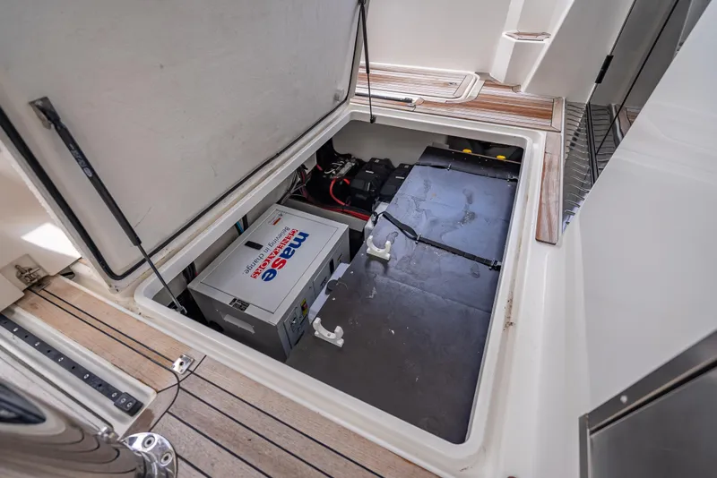 Slide: The Image of 2021 Skamander Monaco boat storage compartment with battery and equipment. - 23
