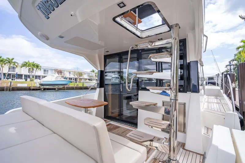 Slide: The Image of Luxurious 2021 Skamander Monaco yacht with modern interior and spiral staircase, docked by waterfront homes. - 24