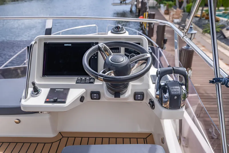 Slide: The Image of Helm of 2021 Skamander Monaco boat with steering wheel and control panel. - 31