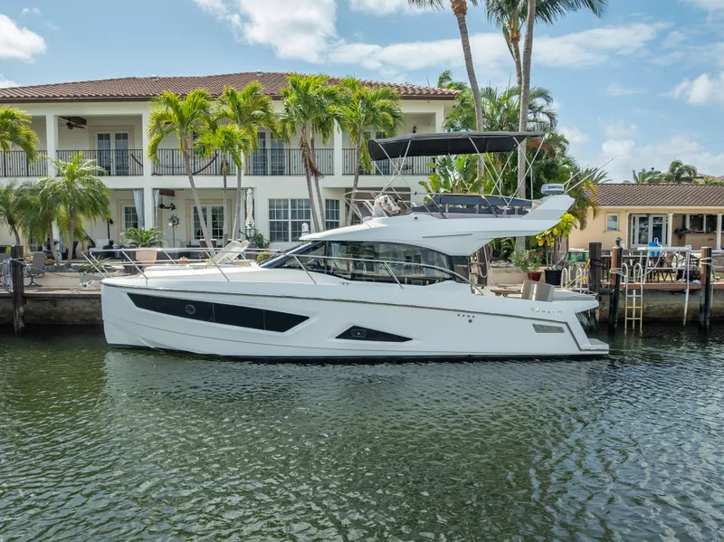 Slide: The Image of 2021 Skamander Monaco yacht docked by a waterfront villa with palm trees. - 39