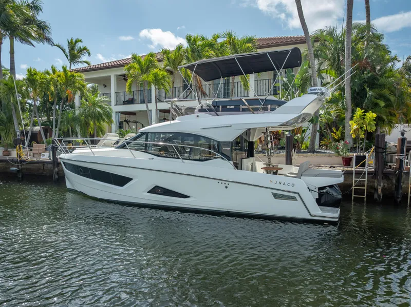 Slide: The Image of 2021 Skamander Monaco yacht docked by a waterfront home with palm trees. - 40