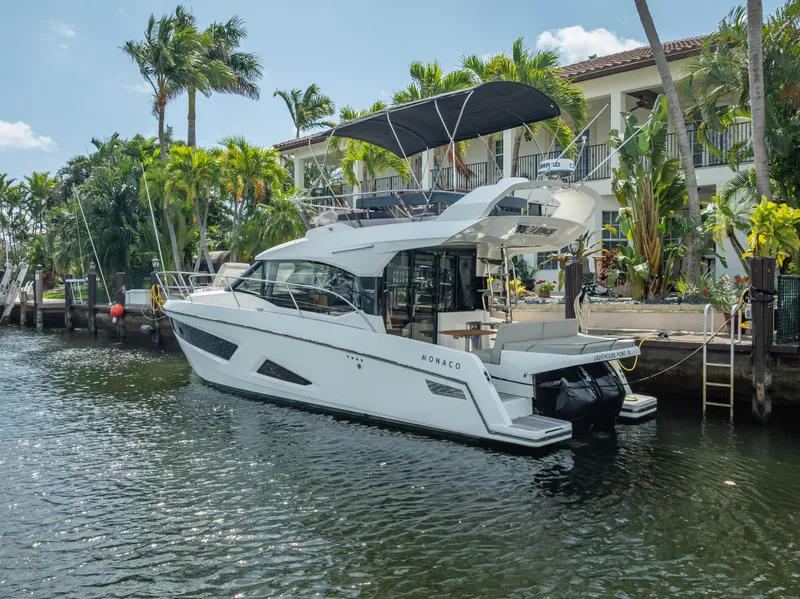 Slide: The Image of 2021 Skamander Monaco yacht docked by tropical waterfront, featuring sleek design and modern amenities. - 41