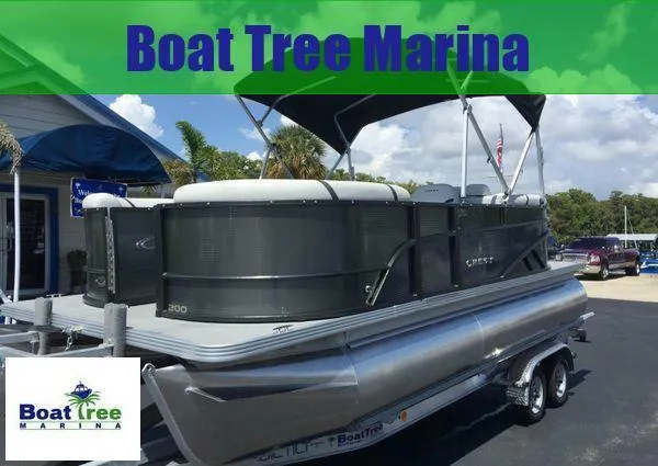 Slide: The Image of 2024 Crest LX 200 SLC pontoon boat at Boat Tree Marina, displayed on a trailer. - 1