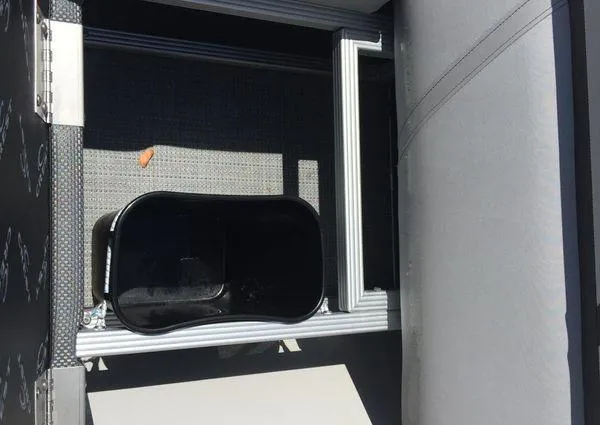 Slide: The Image of 2024 Crest LX 200 SLC interior detail with storage compartment and seating. - 10