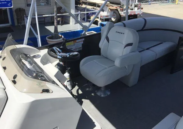 Slide: The Image of 2024 Crest LX 200 SLC boat interior with steering wheel and seating area. - 11