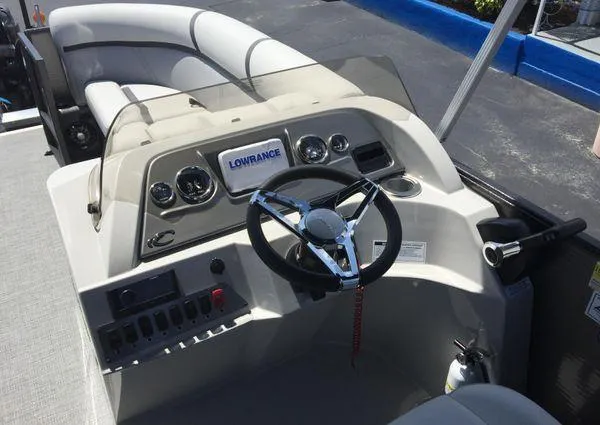 Slide: The Image of 2024 Crest LX 200 SLC boat dashboard with steering wheel and Lowrance display. - 14