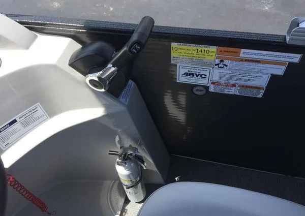 Slide: The Image of 2024 Crest LX 200 SLC boat interior with control panel and safety labels. - 15