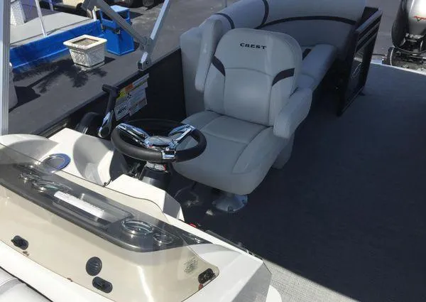 Slide: The Image of 2024 Crest LX 200 SLC boat interior with steering wheel and comfortable seating. - 19