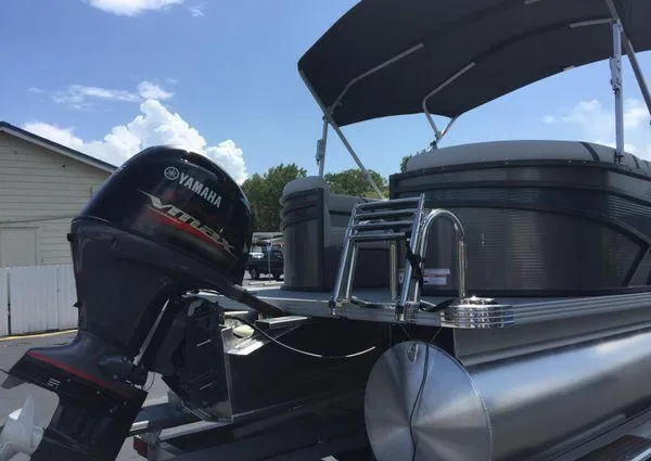 Slide: The Image of 2024 Crest LX 200 SLC pontoon boat with Yamaha outboard motor, docked under a sunny sky. - 25