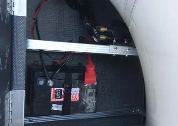 Slide: The Image of Battery compartment of 2024 Crest LX 200 SLC boat, showing wiring and connections. - 26