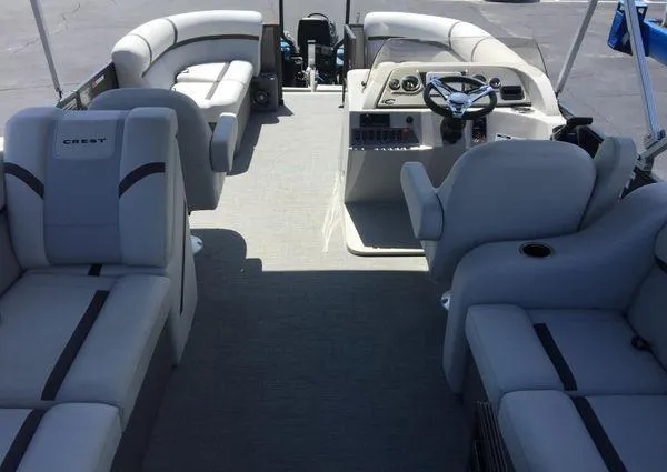 Slide: The Image of 2024 Crest LX 200 SLC pontoon boat interior with plush seating and modern helm. - 27