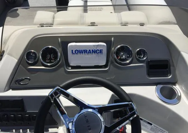 Slide: The Image of 2024 Crest LX 200 SLC dashboard with Lowrance display and chrome steering wheel. - 6