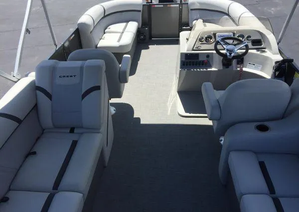 Slide: The Image of 2024 Crest LX 200 SLC pontoon boat interior with plush seating and modern helm. - 7