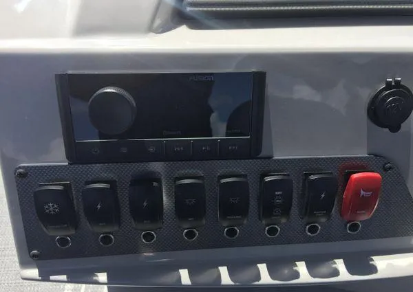 Slide: The Image of Control panel of 2024 Crest LX 200 SLC boat with switches and audio system. - 8