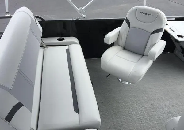 Slide: The Image of 2024 Crest Classic LX 220 SLSC boat interior with gray seating and cup holders. - 10
