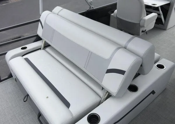 Slide: The Image of 2024 Crest Classic LX 220 SLSC boat interior with gray seating and cup holders. - 11