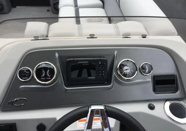 Slide: The Image of 2024 Crest Classic LX 220 SLSC boat dashboard with steering wheel and control panel. - 15