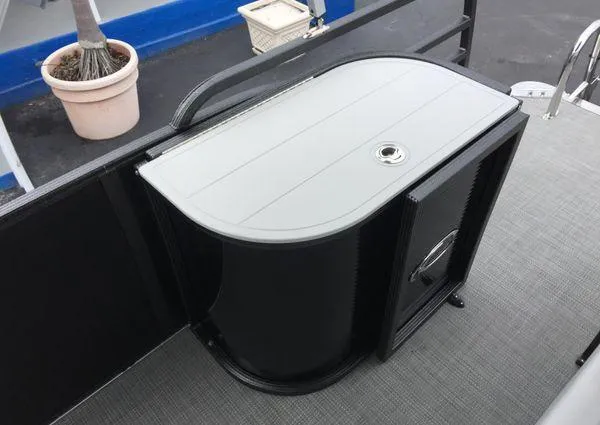 Slide: The Image of Open storage compartment in 2024 Crest Classic LX 220 SLSC boat. - 16