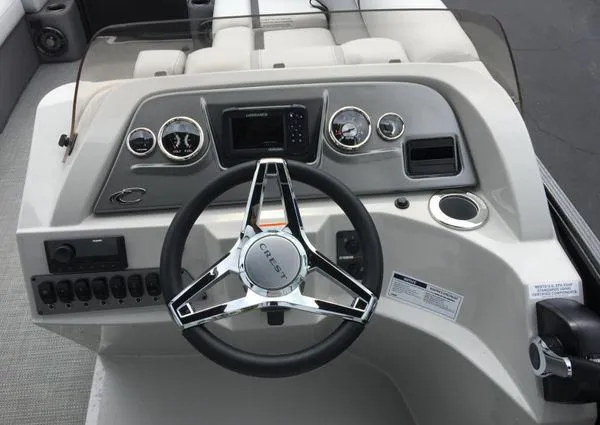 Slide: The Image of Control panel of 2024 Crest Classic LX 220 SLSC boat with switches and display. - 17