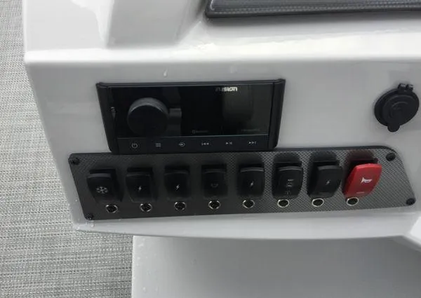 Slide: The Image of 2024 Crest Classic LX 220 SLSC pontoon boat interior with gray seating and helm. - 19