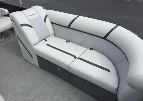 Slide: The Image of 2024 Crest Classic LX 220 SLSC boat interior with cushioned seating and canopy. - 24