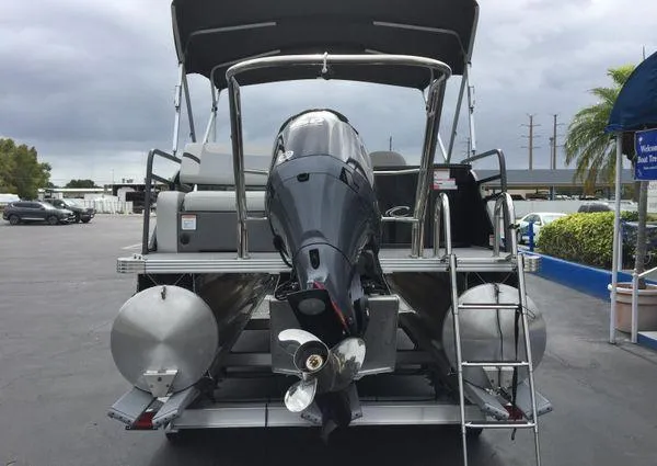 Slide: The Image of 2024 Crest Classic LX 220 SLSC pontoon boat with outboard motor, rear view. - 26