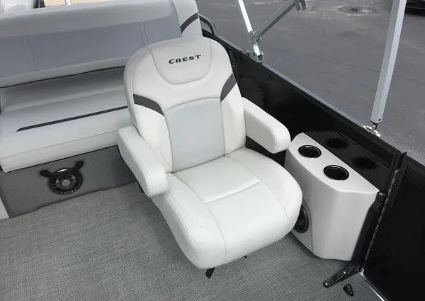 Slide: The Image of 2024 Crest Classic LX 220 SLSC boat interior with plush seating and cup holders. - 28