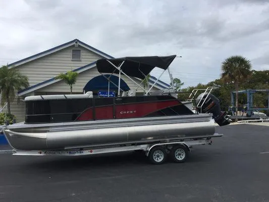 Slide: The Image of 2024 Crest Classic LX 220 SLSC boat interior with steering wheel and captain's chair. - 6