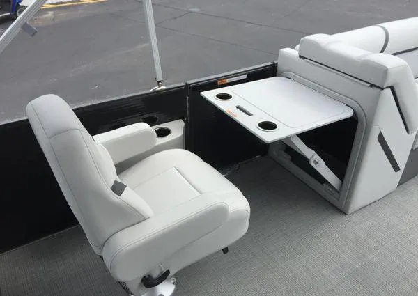 Slide: The Image of 2024 Crest Classic LX 220 SLSC boat interior with gray seating and cup holders. - 9
