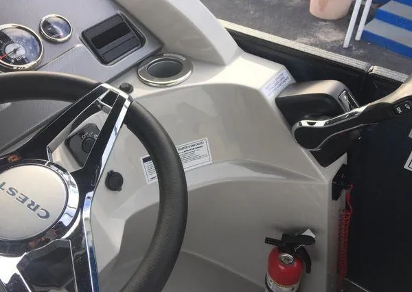 Slide: The Image of 2024 Crest LX 220 SLRC boat dashboard with steering wheel and controls. - 14