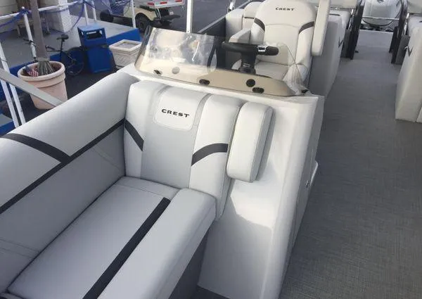 Slide: The Image of 2024 Crest LX 220 SLRC boat interior with plush seating and modern helm. - 17