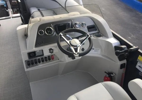 Slide: The Image of 2024 Crest LX 220 SLRC boat dashboard with steering wheel and control panel. - 18