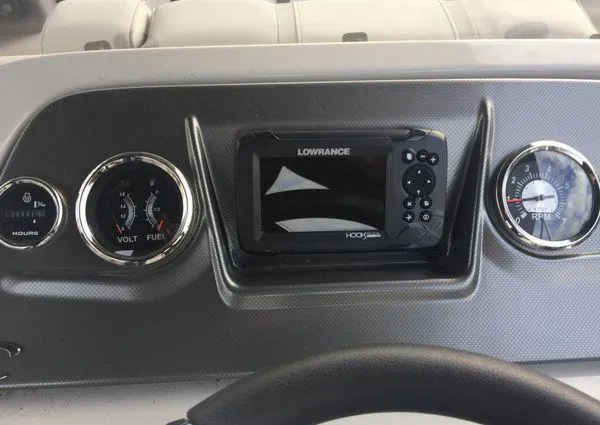 Slide: The Image of Dashboard of 2024 Crest LX 220 SLRC with gauges and Lowrance display. - 19