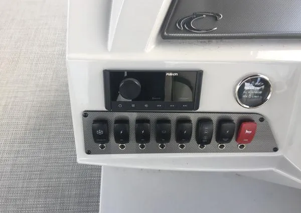 Slide: The Image of Control panel of 2024 Crest LX 220 SLRC boat with switches and audio system. - 24