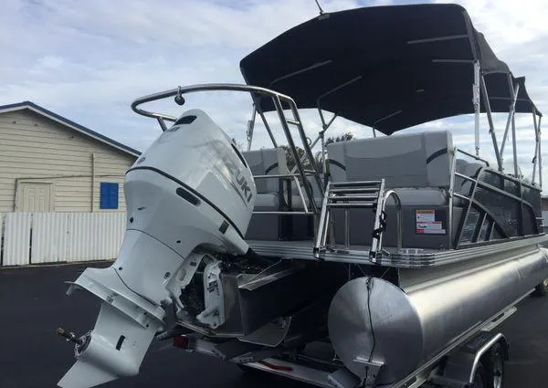 Slide: The Image of 2024 Crest LX 220 SLRC pontoon boat on trailer, parked near a deli. - 5