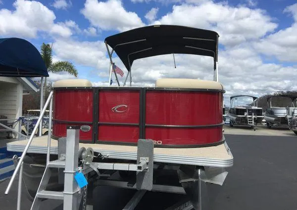 Slide: The Image of 2024 Crest LX 220 SLC pontoon boat with red exterior on a trailer. - 13