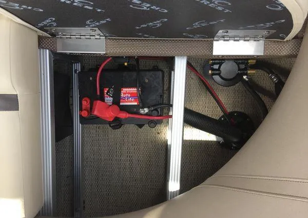 Slide: The Image of 2024 Crest LX 220 SLC boat battery compartment with wiring and components. - 14
