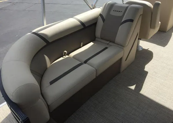 Slide: The Image of 2024 Crest LX 220 SLC boat interior with beige cushioned seating. - 18
