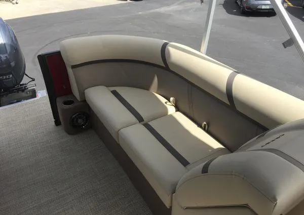 Slide: The Image of 2024 Crest LX 220 SLC boat interior with beige seating and cup holders. - 19