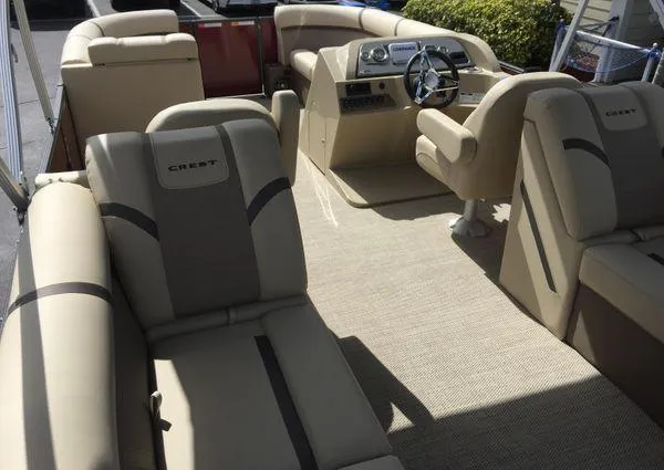 Slide: The Image of 2024 Crest LX 220 SLC pontoon boat interior with beige seating and steering console. - 22