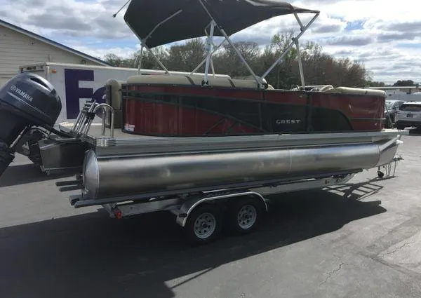 Slide: The Image of 2024 Crest LX 220 SLC pontoon boat on trailer, featuring Yamaha outboard motor. - 3