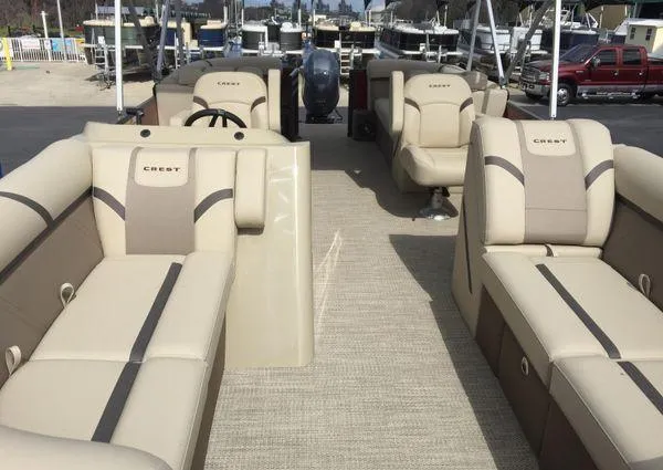 Slide: The Image of 2024 Crest LX 220 SLC pontoon boat interior with beige seating and steering console. - 4
