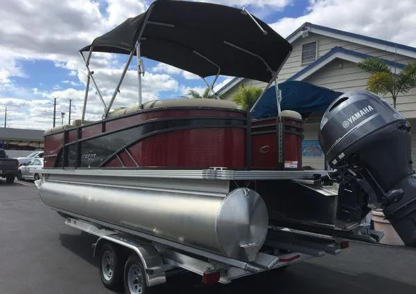 Slide: The Image of 2024 Crest LX 220 SLC pontoon boat with Yamaha motor on trailer, under cloudy sky. - 5