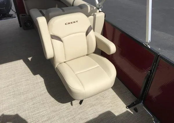 Slide: The Image of 2024 Crest LX 220 SLC boat seat, beige upholstery, armrests, on deck. - 6