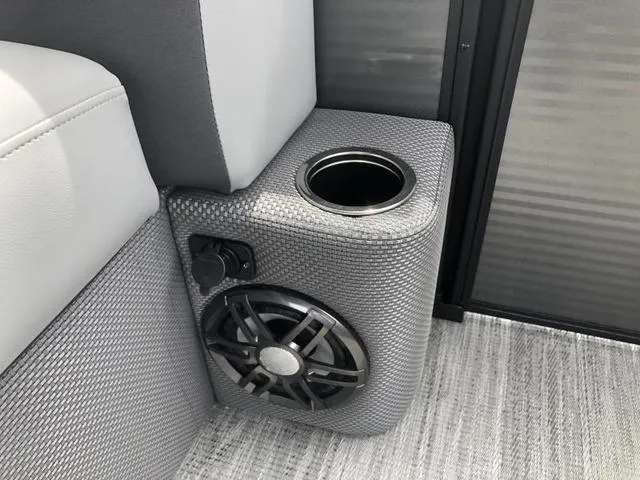 Slide: The Image of 2025 Crest Classic LX 220 SLRC boat seat with gray upholstery and cup holders. - 12