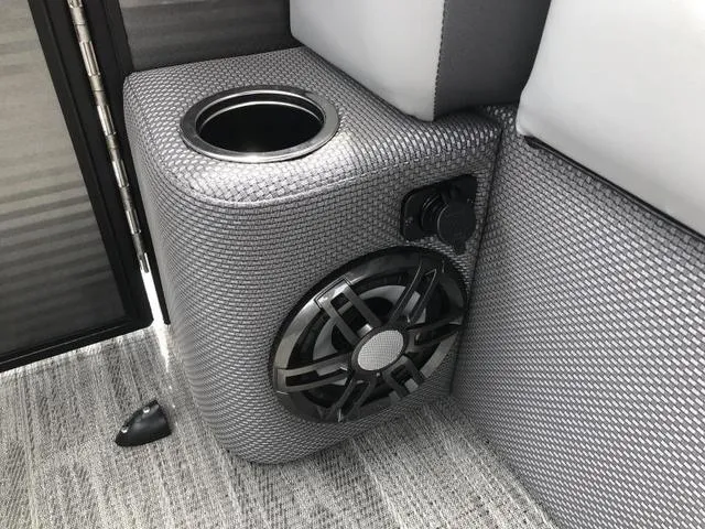 Slide: The Image of 2025 Crest Classic LX 220 SLRC pontoon boat with gray seating at a dock. - 13