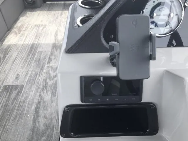 Slide: The Image of 2025 Crest Classic LX 220 SLRC boat interior with gray cushioned seating and modern design. - 19